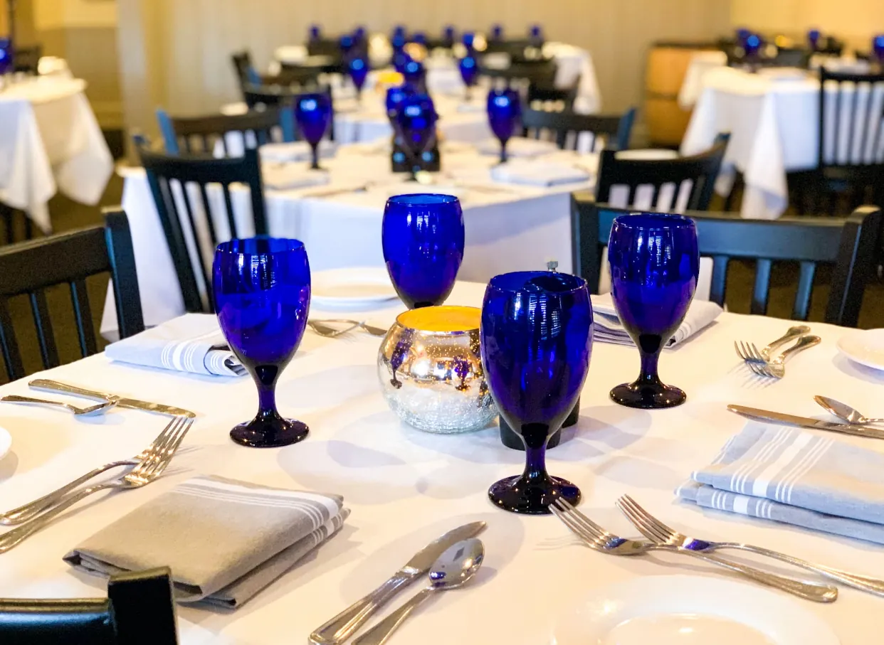 Tables set with cobalt-blue glasses