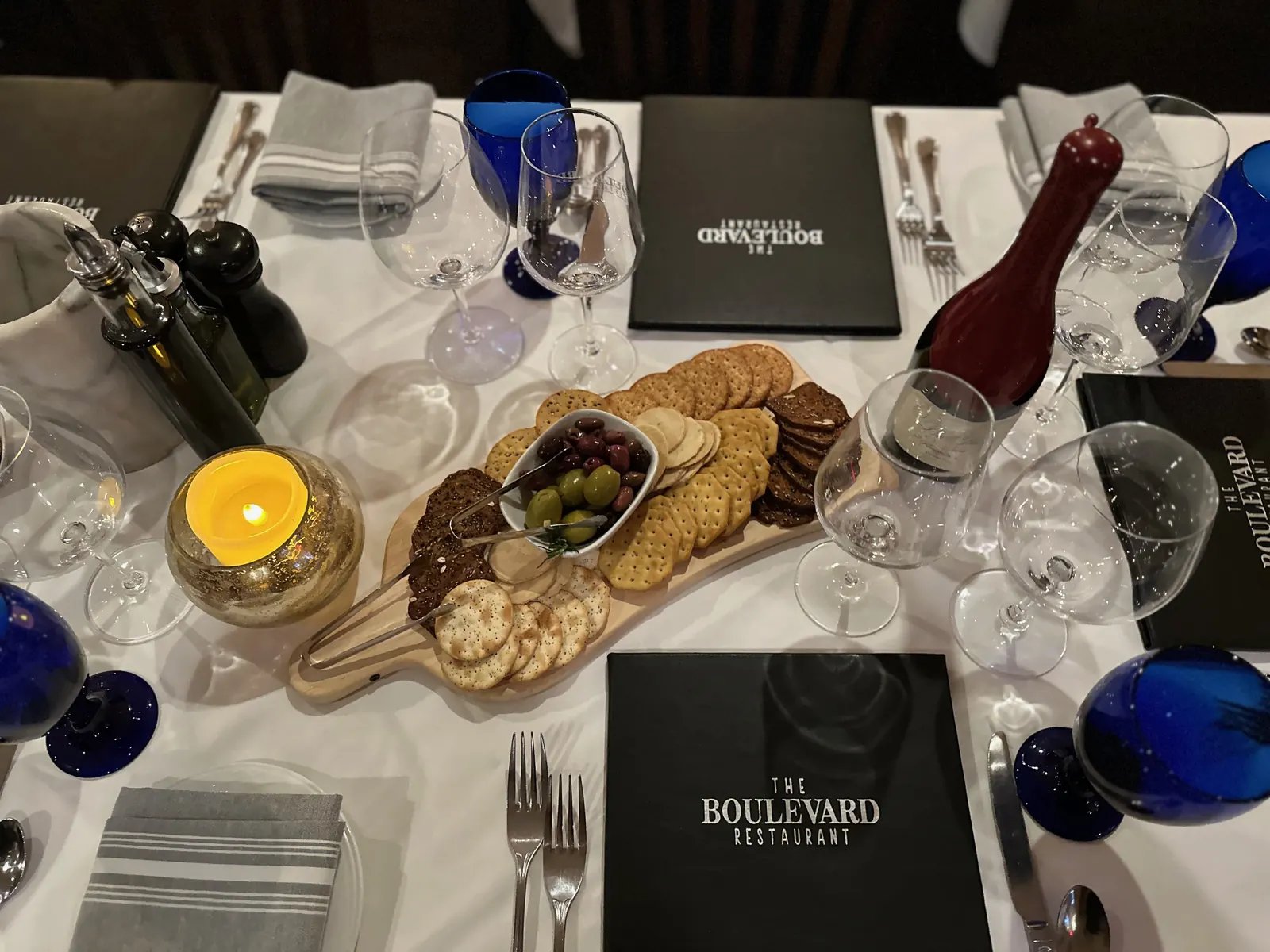A table set with a cheese board and wine