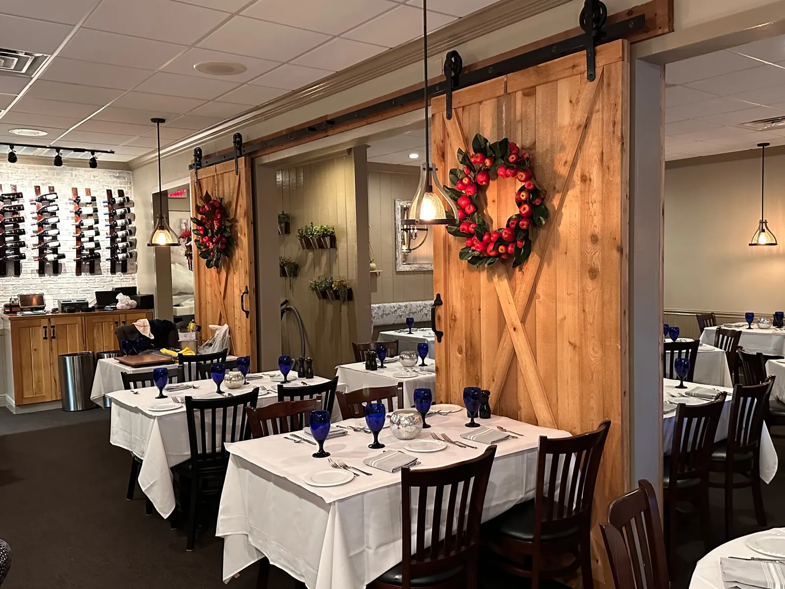 Dining room with barn doors and a wine wall