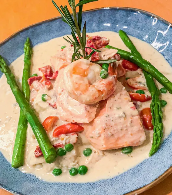 Salmon and shrimp in a cream sauce with asparagus